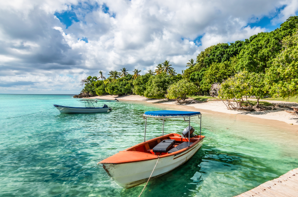 Two boats in the water on the coast by sandy beach