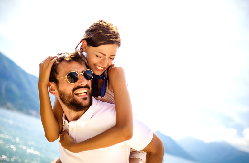 A smiling man and woman hold each other affectionately, showcasing their happiness in an embrace. 