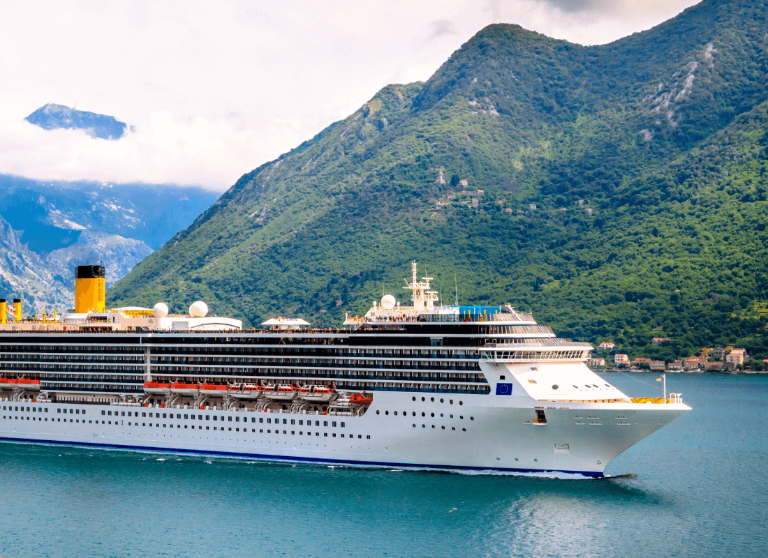 Cruise sailing with a mountain in the background