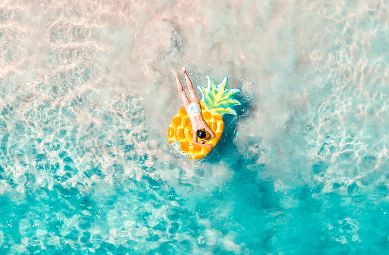 Aerial view of person lying on a life preserver in the water