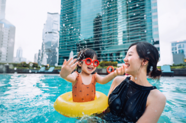 woman in pool with child