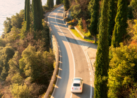 Car driving down winding country road