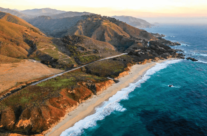 Coast with sea on one side and mountains on the other