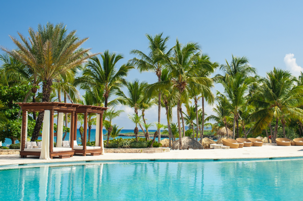 Pool and cabanas at a luxury resorty by the beach