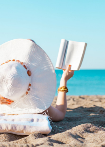 Woman reading a book on the beach