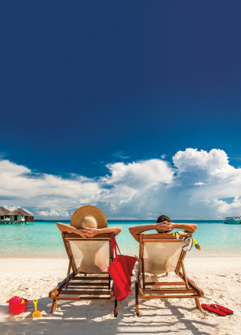 Two people sunbathing on the beach with blue sky in the background