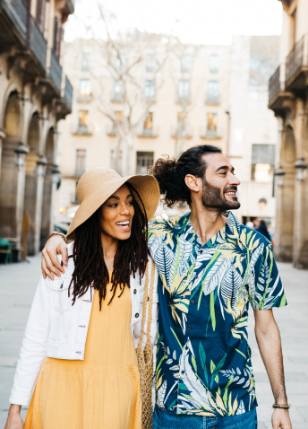 Two people hugging and smiling on the street