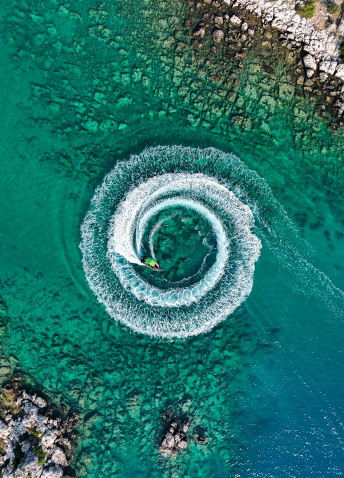 Aerial view of a circle in the water, made by a water transport