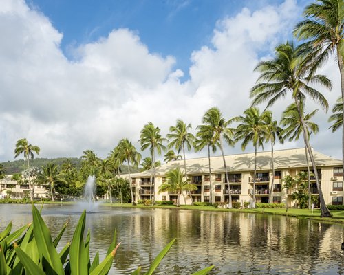 Scenic exterior view of the Kauai Beach Villas resort alongside the waterfront.